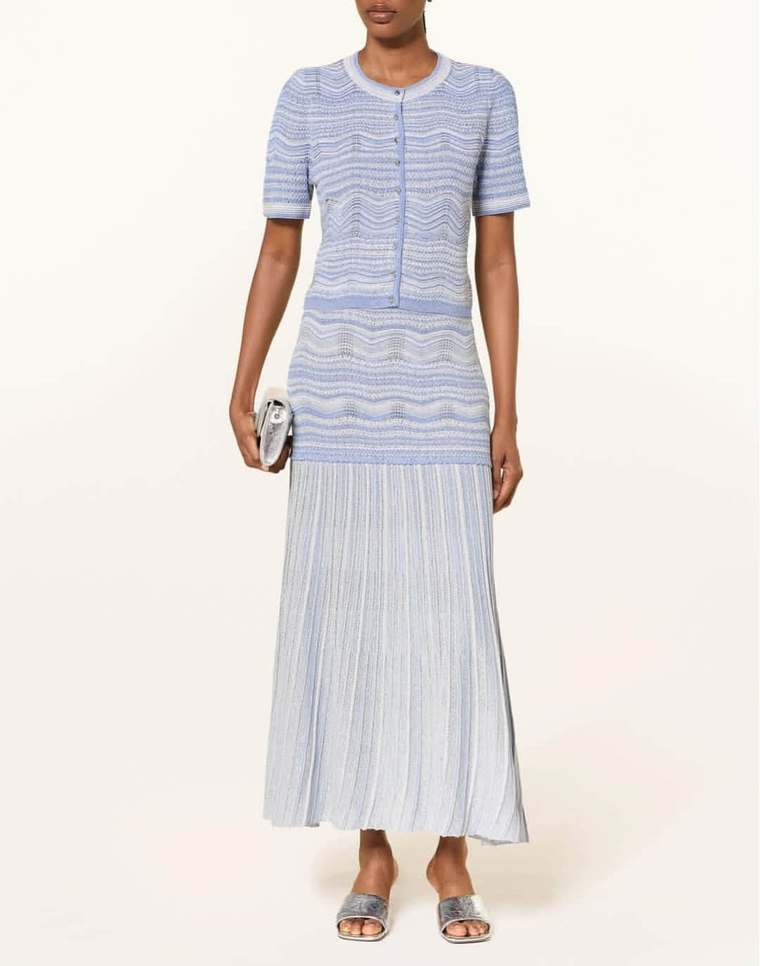 Women's short sleeved cardigan paired with a mid length skirt two-piece set