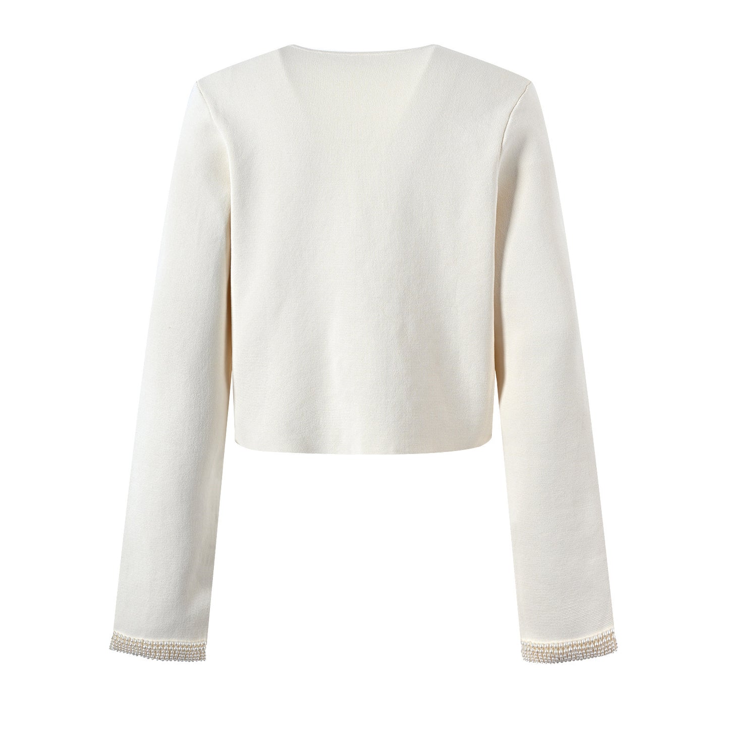 A woman's beige cardigan paired with a slim-fitting knitted dress