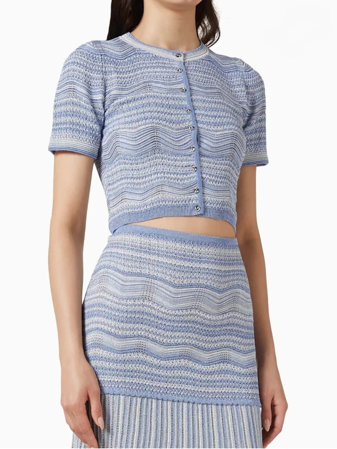 Women's short sleeved cardigan paired with a mid length skirt two-piece set